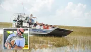 A group of tourists is enjoying a ride on an airboat through a waterway with sparse vegetation.