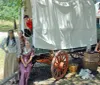 The image shows a museum exhibit featuring a tipi artifacts and informative displays about the Comanche and Kiowa peoples