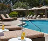 The image shows a serene poolside area with loungers umbrellas and refreshing beverages evoking a sense of luxury and relaxation