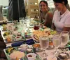 A group of people is sitting around a table at a restaurant enjoying a variety of dishes and each others company