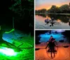 Two people are enjoying a nighttime adventure in a transparent kayak illuminated by a green light highlighting the water below them