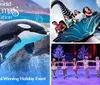 Two killer whales are leaping out of the water during a show at a Christmas-themed event at SeaWorld