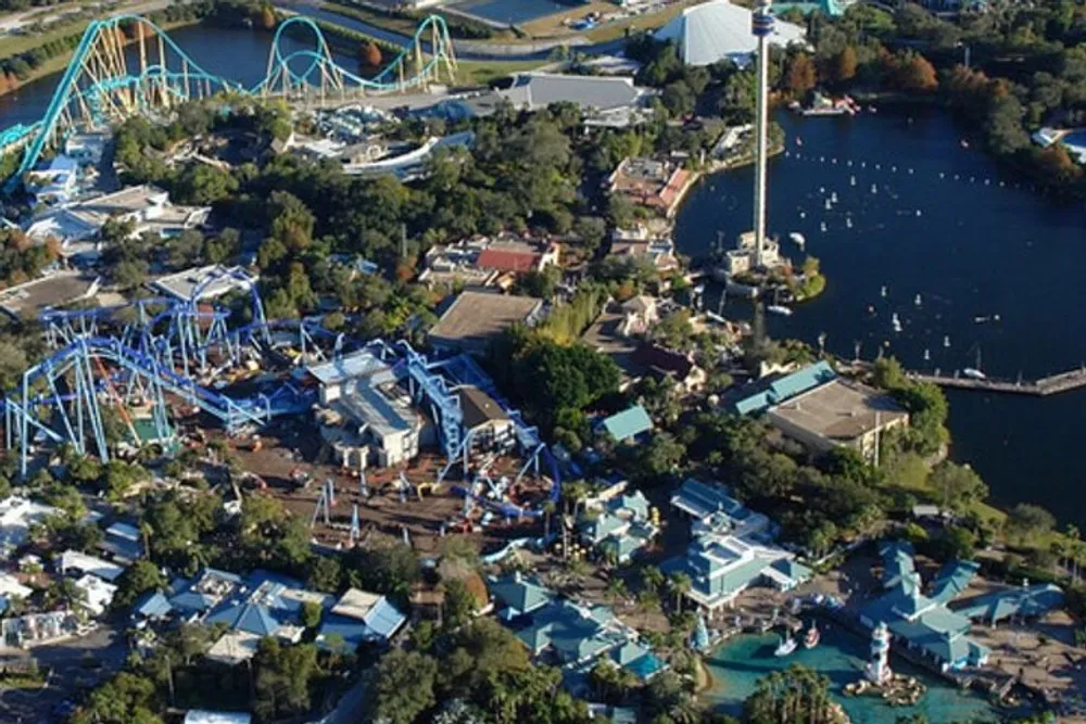 An aerial view of a theme park featuring a variety of roller coasters and water attractions surrounded by lush greenery