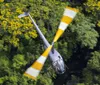 The image shows the cockpit view from a helicopter overlooking a lush landscape with roads and trees taken from a high vantage point mid-flight