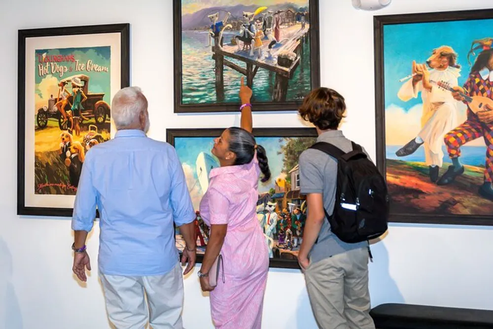 Three individuals are attentively viewing a collection of vibrant paintings at an art gallery