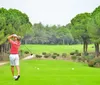 A person is preparing to take a golf shot on a lush green course