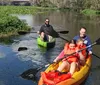 A family is kayaking on a scenic river with a close-up inset of a manatee