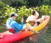 A family is kayaking on a scenic river with a close-up inset of a manatee