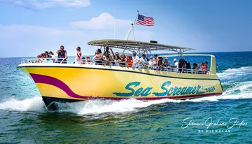 A group of people enjoys a sunny day on a speeding yellow boat named 