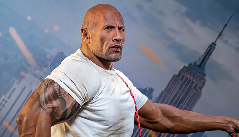 A muscular man poses confidently with a determined expression in front of a blurred city skyline backdrop