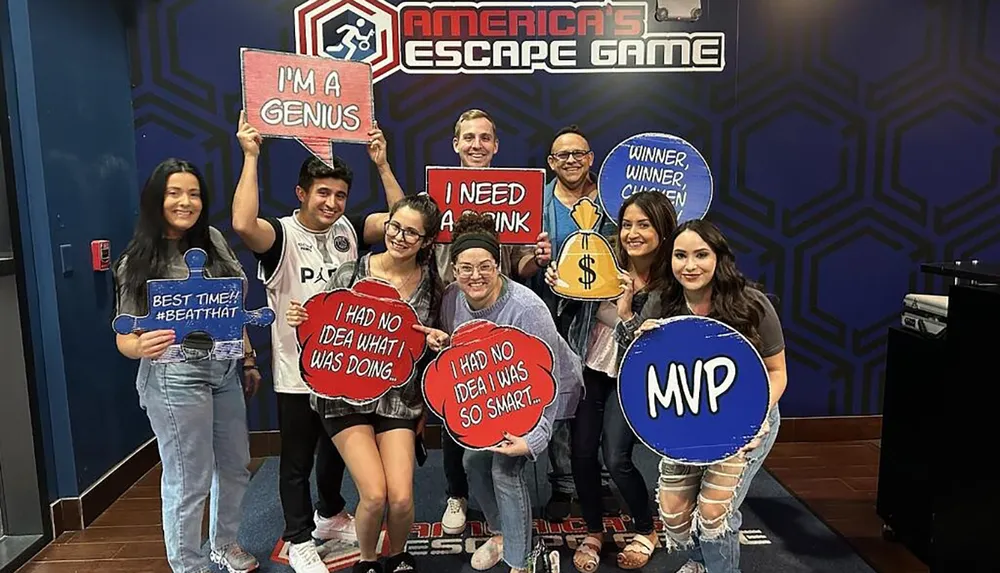 A group of people is celebrating with fun signs smiles and a sense of accomplishment after an escape room experience at Americas Escape Game