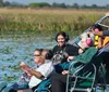 A group of people wearing headphones is enjoying a ride on a boat in a scenic wetland area