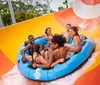 A group of people are enjoying a water slide ride together in an inflatable raft
