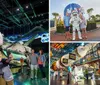 Two boys take a selfie in front of the Space Shuttle Atlantis exhibit while other visitors explore the display