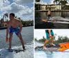 A person is wake surfing on a wave created by a boat on a sunny day with palm trees and houses in the background