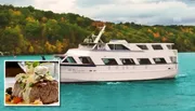 The image showcases a white yacht cruising on turquoise waters with a colorful autumnal forest in the background, inset with a close-up of a gourmet steak dish suggesting a luxury dining experience onboard.