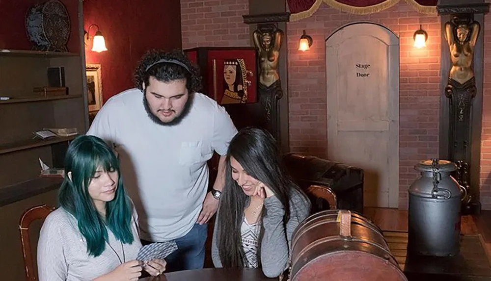 Three people are examining clues together in an intriguing escape room with a vintage magic theme