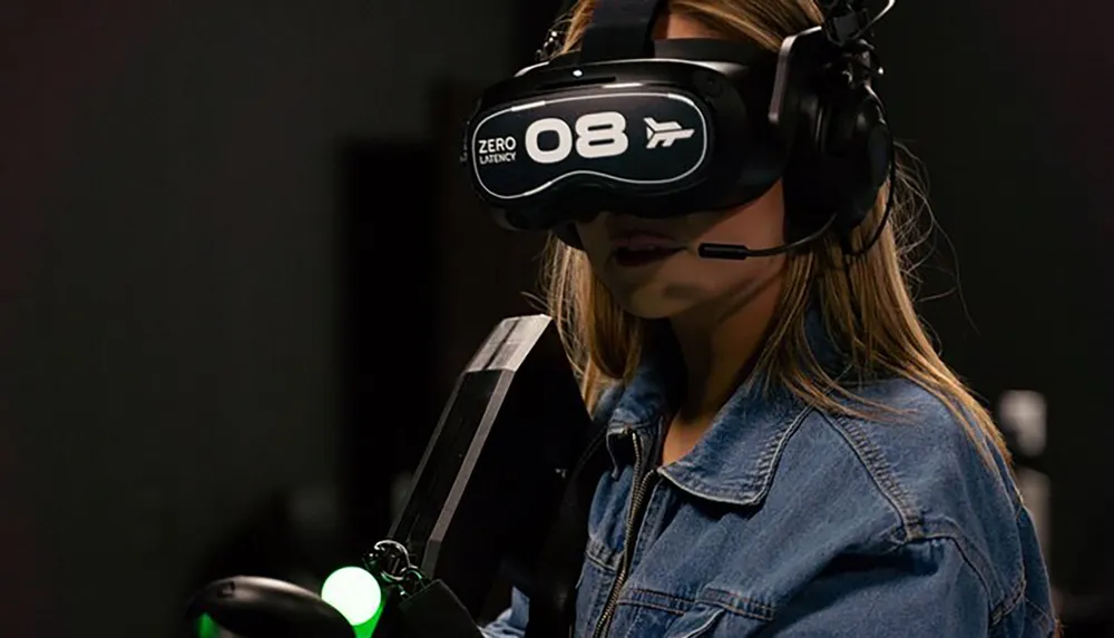 A person is wearing a virtual reality headset and headset with a microphone likely immersed in a VR experience