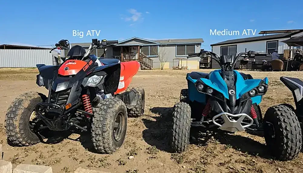 The image shows two all-terrain vehicles ATVs of different sizes labeled as Big ATV and Medium ATV parked on a dirt surface in front of a house