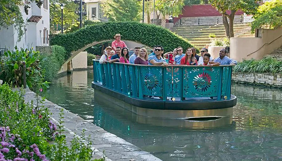 A group of people enjoy a guided boat tour along a scenic urban waterway.