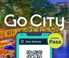 The image shows an advertisement for Go Citys Explorer Pass with an illustrated smartphone displaying a QR code set against a vibrant backdrop of a riverwalk scene at dusk