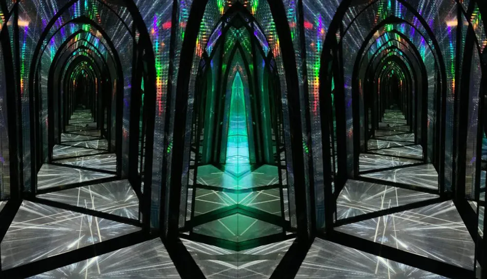 The image shows a futuristic-looking corridor with reflective surfaces and arch-shaped frames illuminated by multi-colored lights that create a mesmerizing spectrum effect as they reflect off the walls and floor