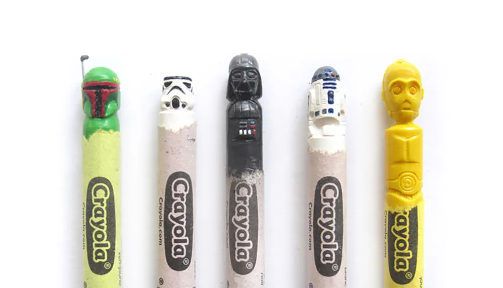 The image shows a creative arrangement of Crayola crayons carved into the likenesses of characters from a popular science fiction franchise