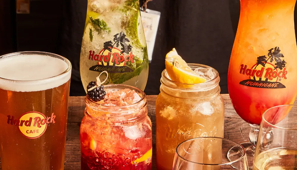 The image showcases a variety of branded alcoholic beverages with the Hard Rock Cafe logo served in different glasses and jars on a wooden surface