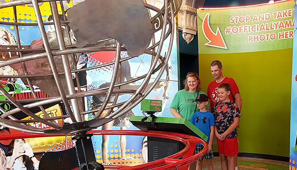A family is posing for a photo in front of a colorful backdrop at an amusement park or arcade with an invitation to take an official photo indicated by the signage