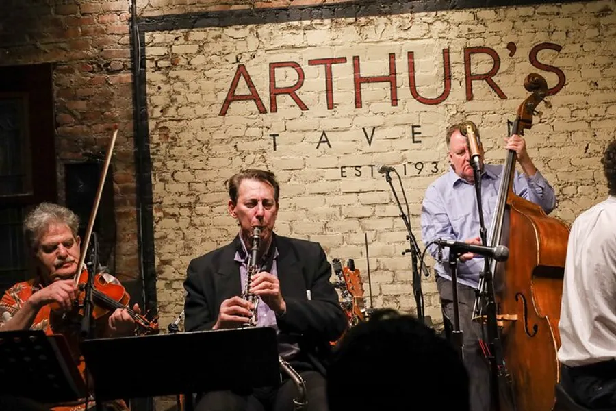 A trio of musicians with a violin, clarinet, and double bass perform live at Arthur's Tavern, an establishment established in 1937.