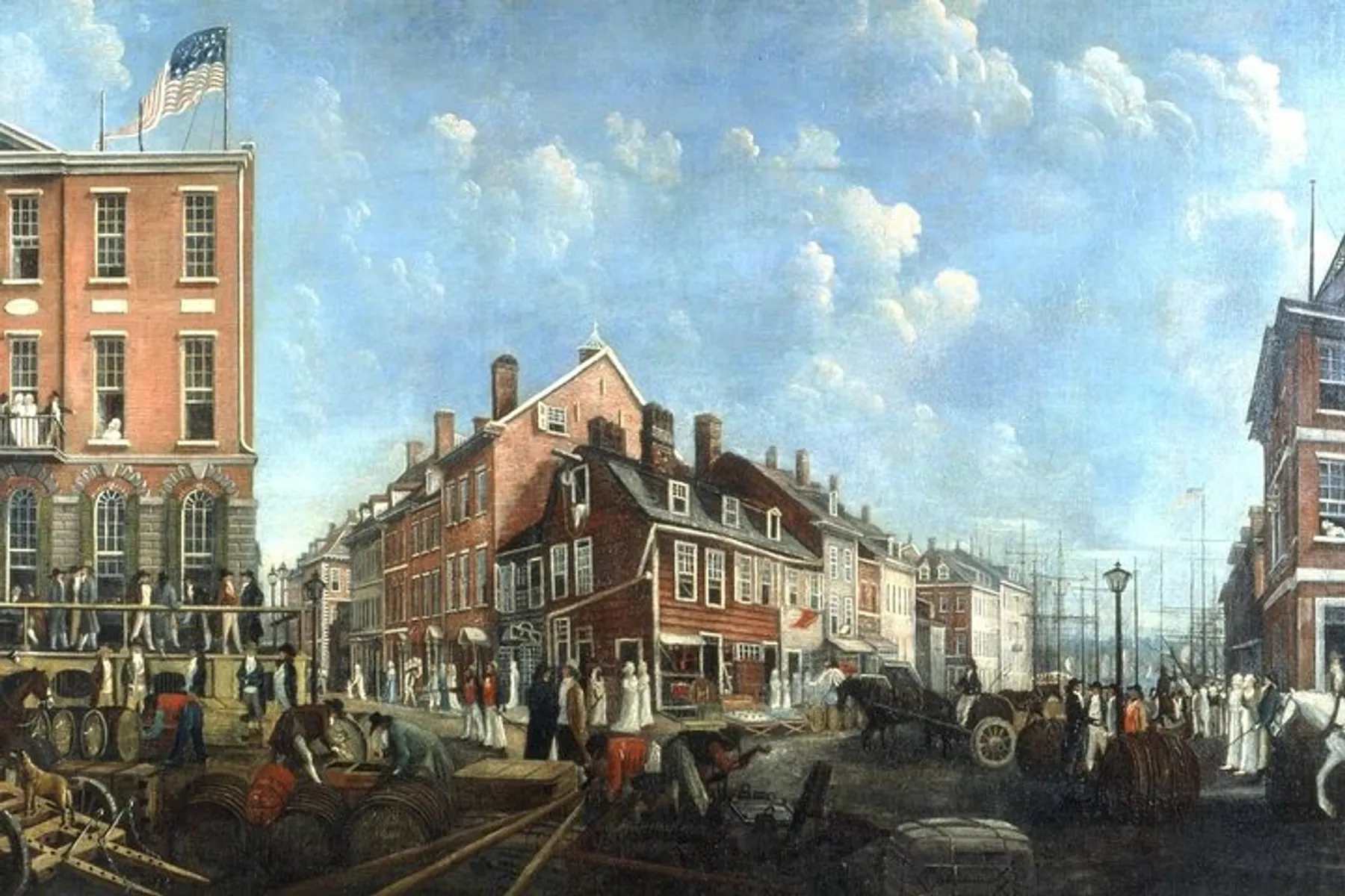The image depicts a bustling colonial American street scene with people in period attire, carts, barrels, and a building flying an early American flag.