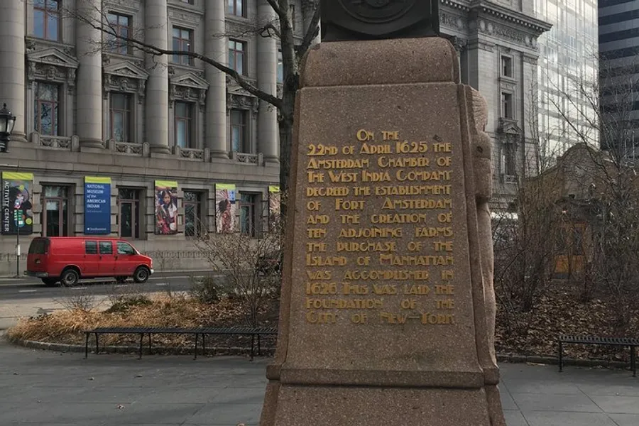 The image shows an informational plaque commemorating the establishment of Fort Amsterdam and the purchase of Manhattan Island in 1626, which laid the foundation for New York City, set against a backdrop of city buildings and a red van.