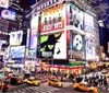 The image shows a vibrant and bustling Times Square at night illuminated by bright billboards and alive with the iconic yellow cabs of New York City