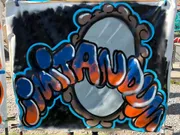 The image shows a colorful graffiti-style painting with the word 