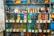 A shelving display is filled with an assortment of colorful candies and chocolates in a retail store.