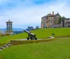 The image displays the historic Calton Hill in Edinburgh Scotland with its iconic monuments and an old cannon under a cloudy sky