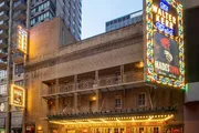The image shows the illuminated marquee and signage of the Walter Kerr Theatre advertising the musical 'Hadestown'.